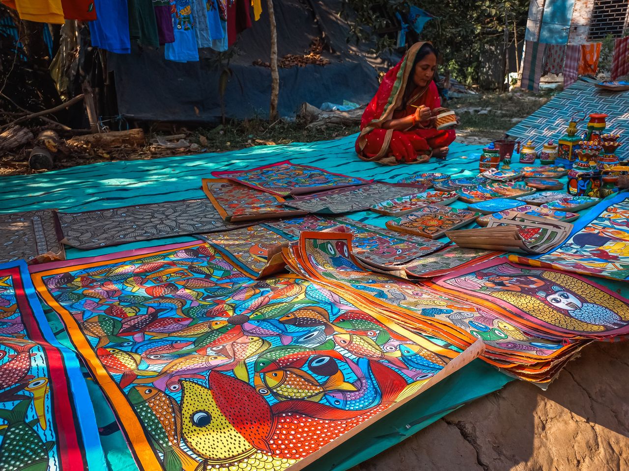 Colorful traditional Indian crafts on display with a woman in vibrant attire.