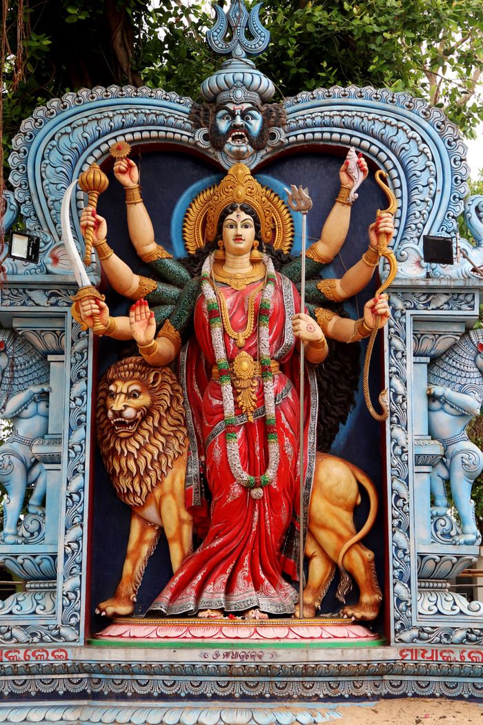 gallery-3 Colorful statue of a Hindu goddess with lion in Urali, India, showcasing traditional artistry.