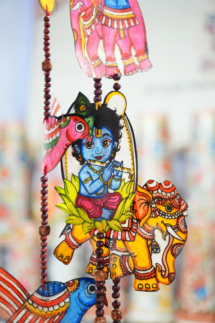 Colorful traditional hanging decor featuring Lord Krishna and elephants, captured in Bhubaneswar, India.